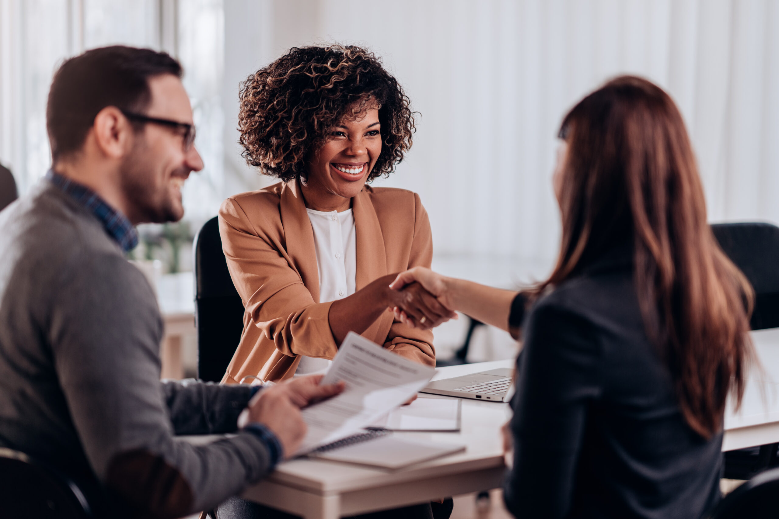 Woman shaking hands after successful job interview You already positioned your value—now build the connection!