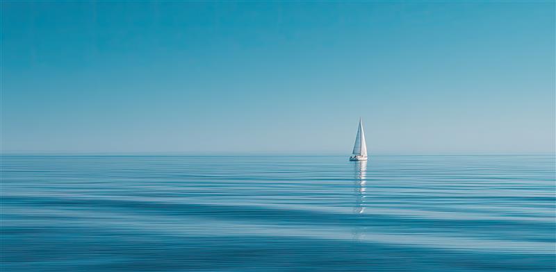 Calm ocean horizon with a sailboat symbolizing leadership resilience and perseverance through rejection.